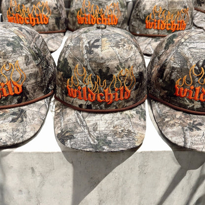 Camouflage hat with "wild child" and flames embroidered on it 