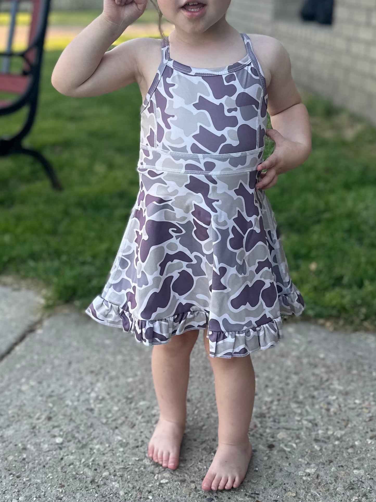 child wearing a camo athletic dress
